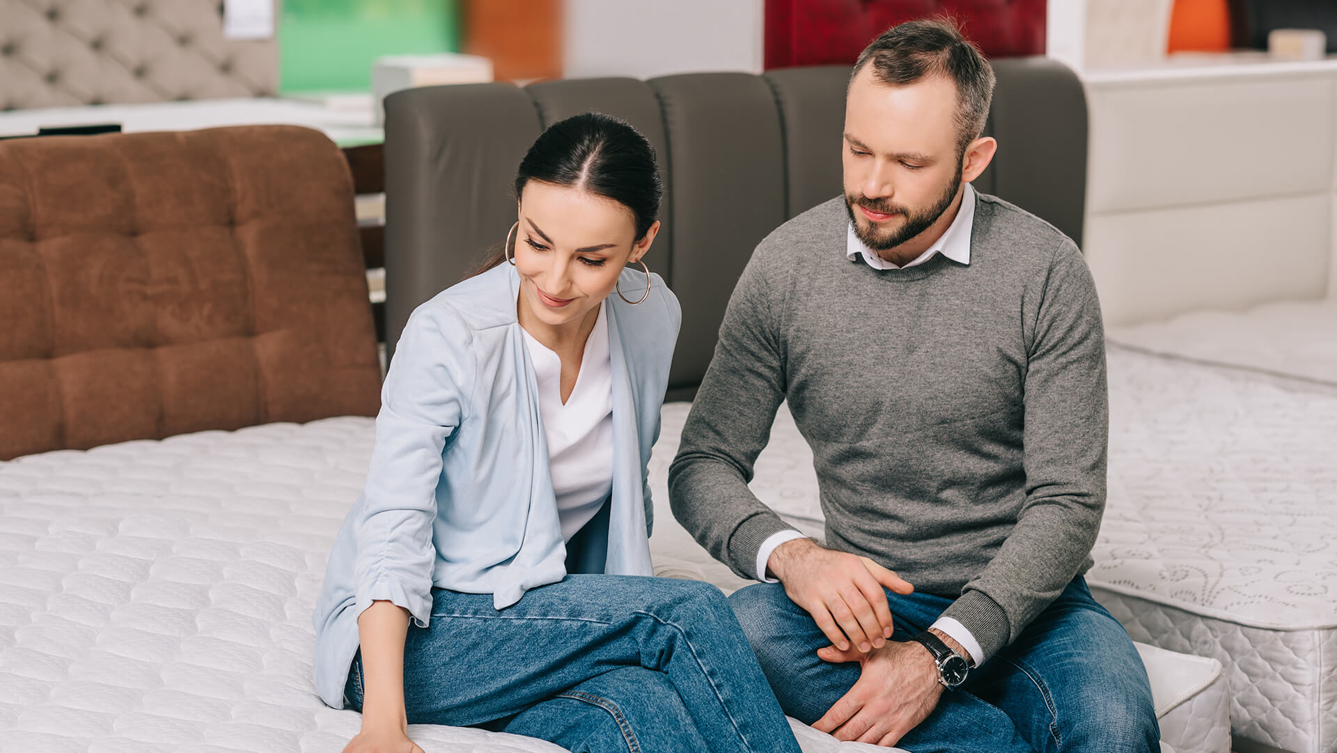 Couple sitting on mattress